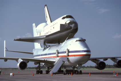 Angular view of one of NASA's space shuttles sitting on top of a 747 jet aircraft used to move it from its landing point back to the launching site in Florida, U.S.A. This was taken at Ellington Airforce Base in Texas, U.S.A. Piggy-Back Space Shuttle On Ground At 45 Degree Angle
